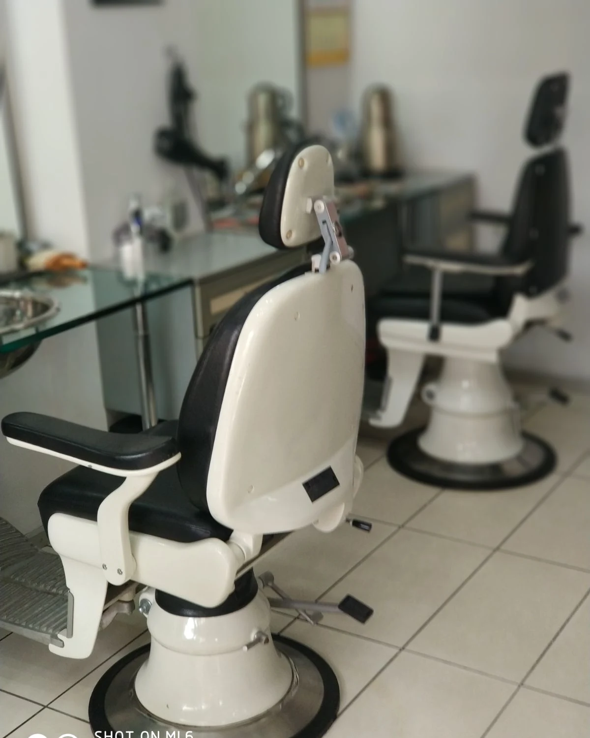 Classic white barber chair inside Rimedzo Barber Shop